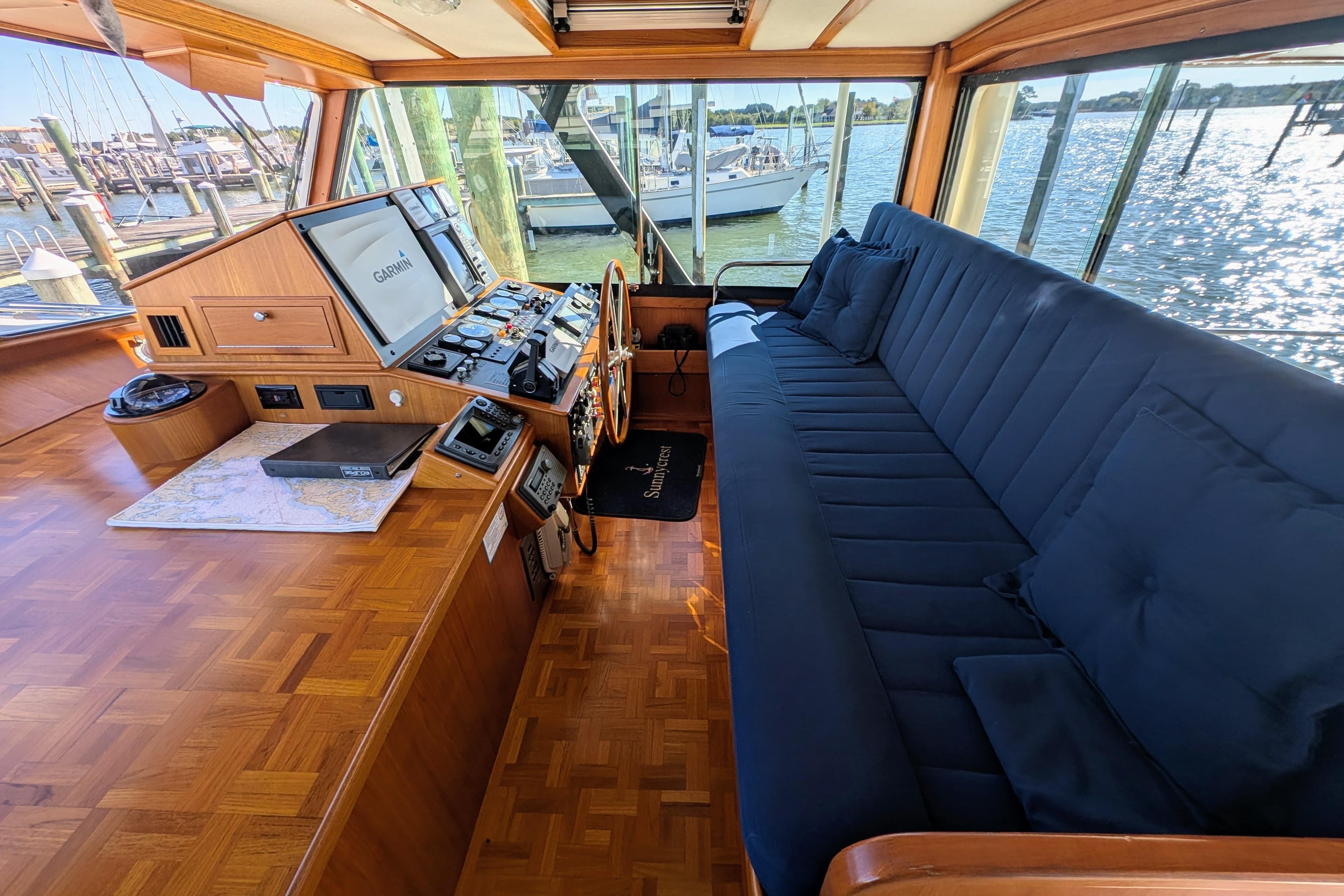 Interior of 2001 Dettling 51 yacht with navigation equipment and blue seating.