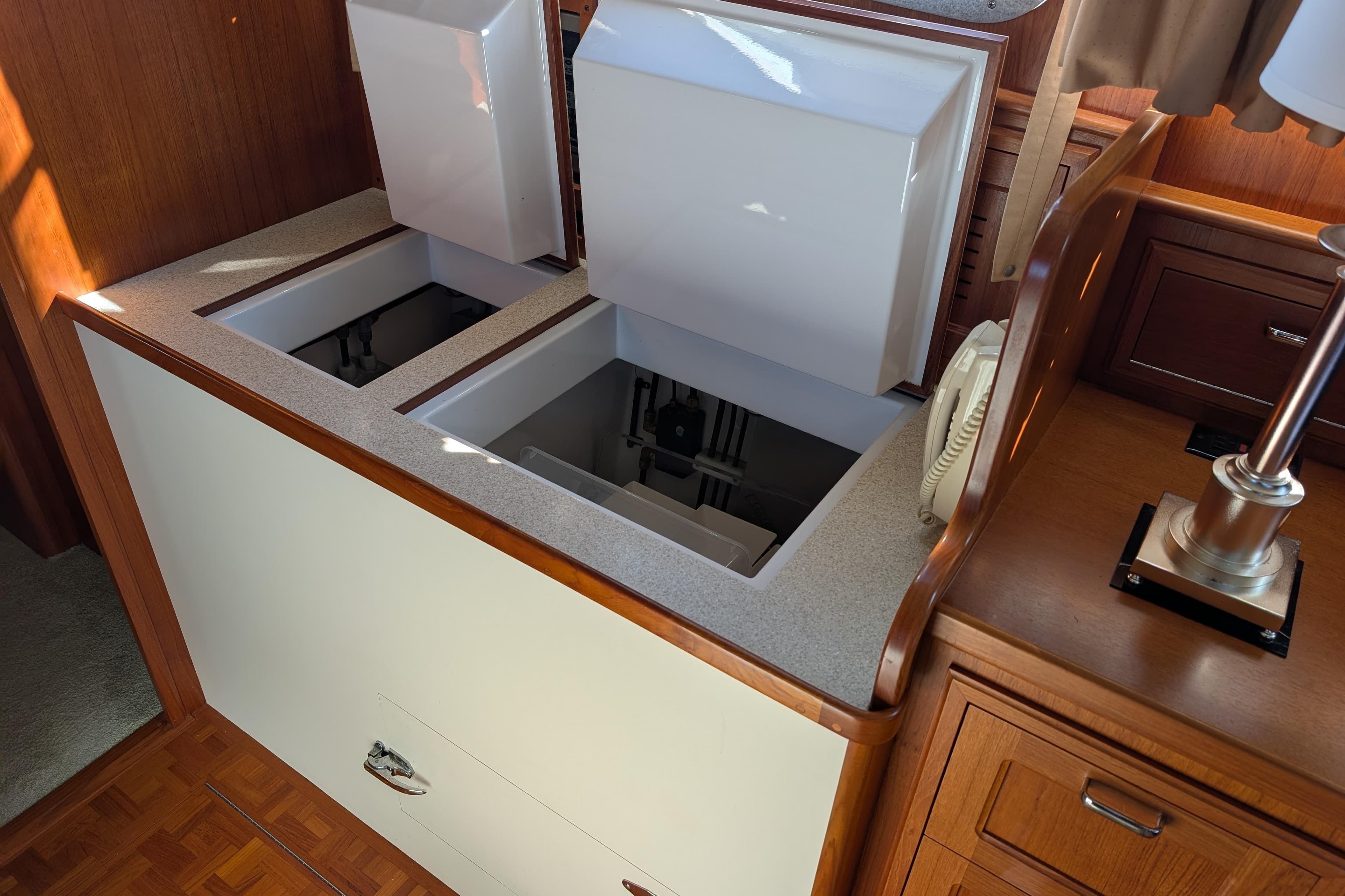 Open storage compartments in a 2001 Dettling 51 yacht interior.