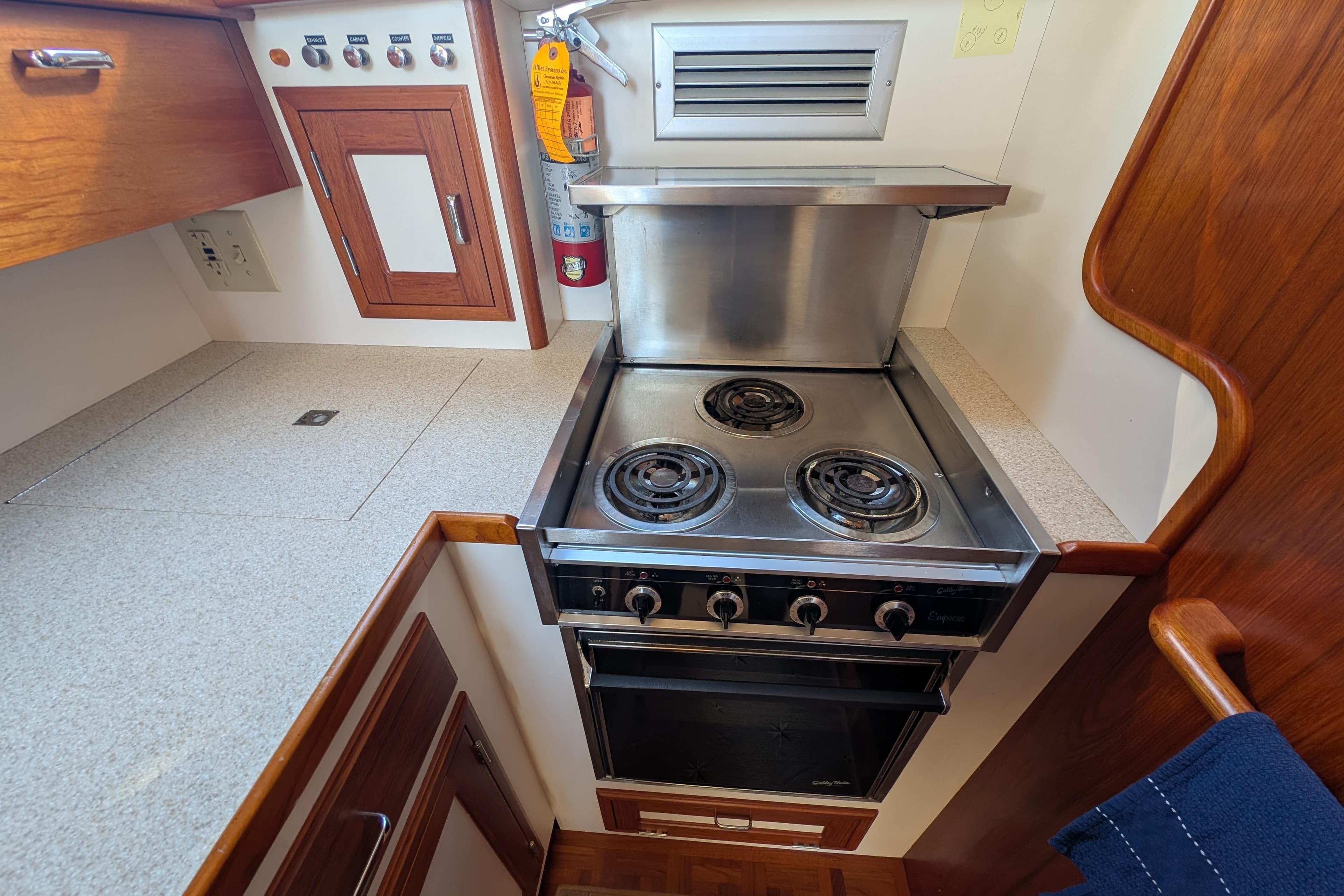 Compact kitchen area in a 2001 Dettling 51 yacht with stove and oven.