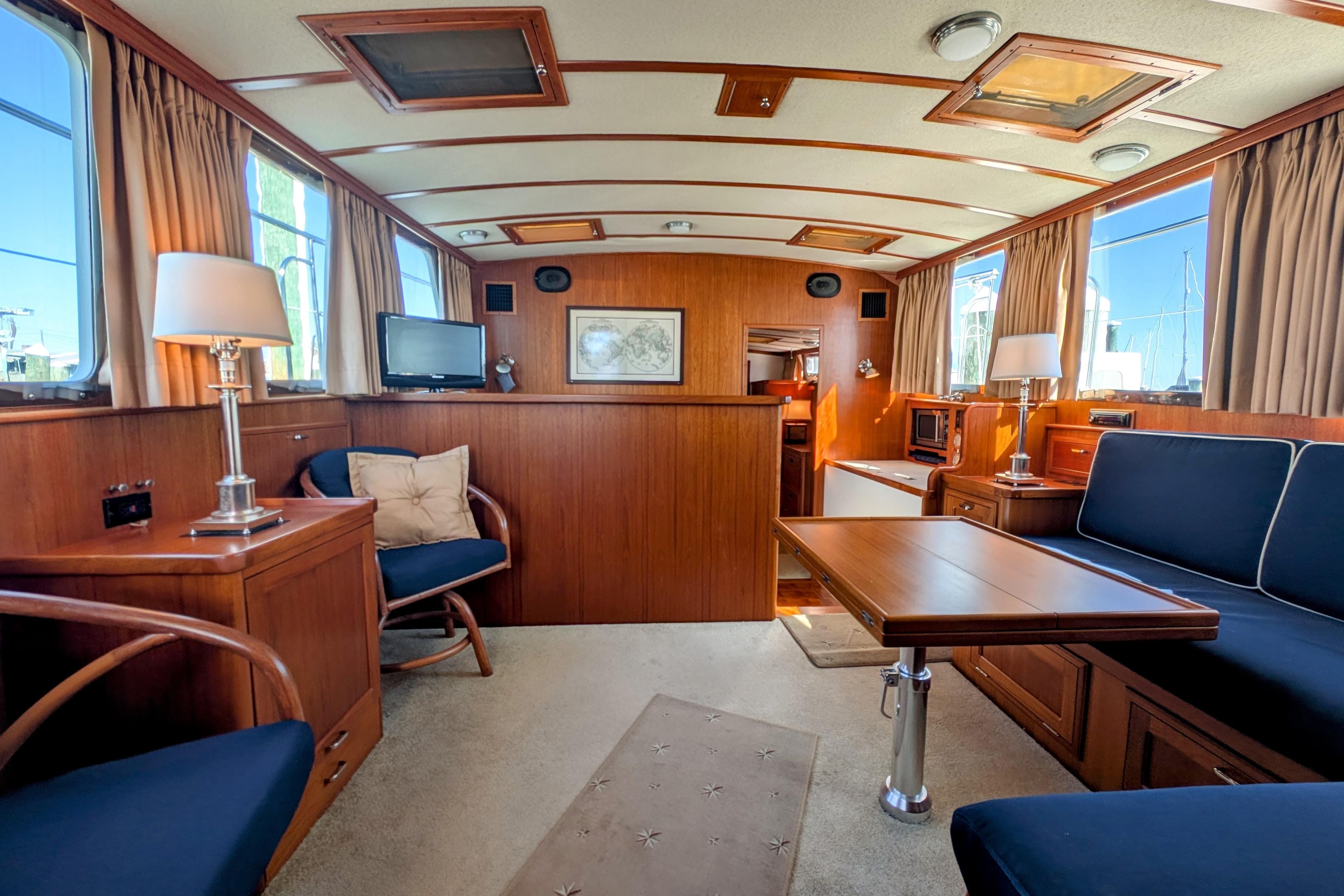 Luxurious interior of a 2001 Dettling 51 yacht with wood paneling and elegant furnishings.