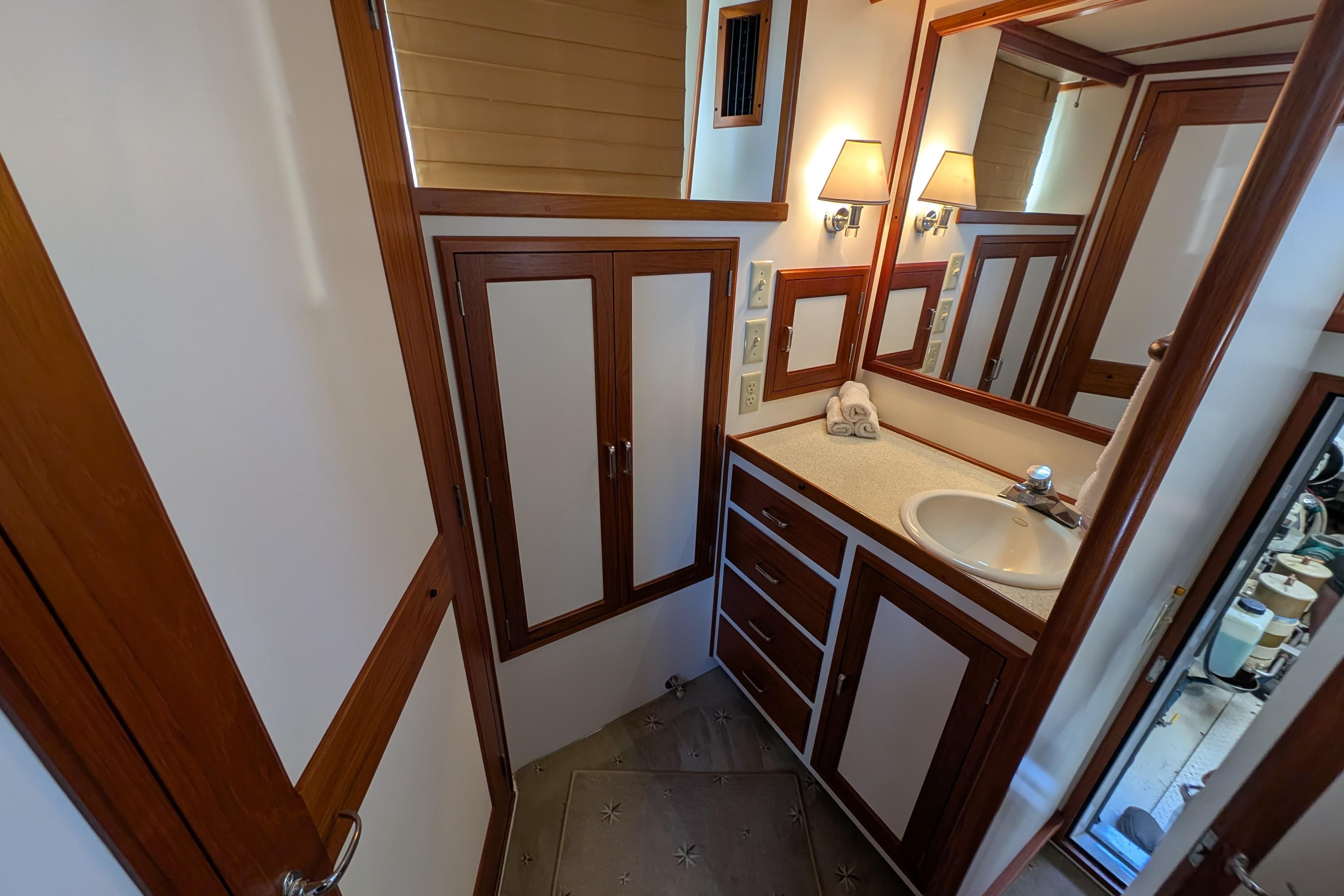 Luxurious bathroom in 2001 Dettling 51 yacht, featuring wood accents and modern fixtures.
