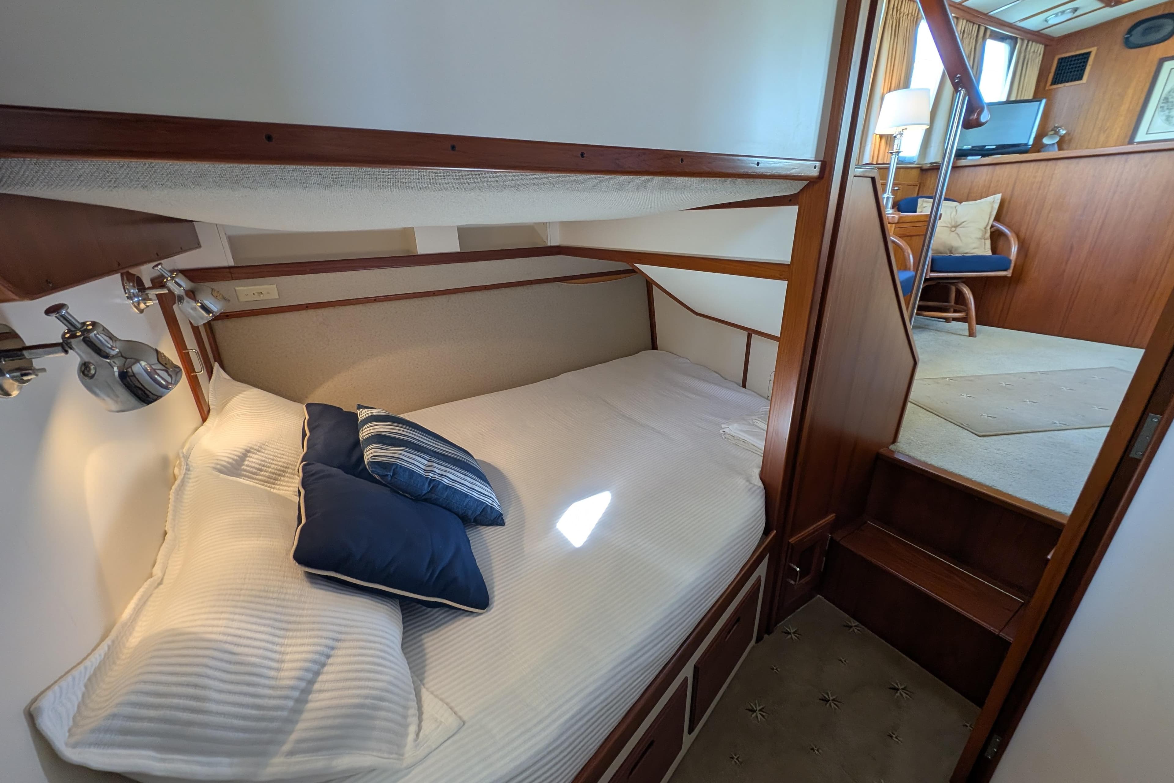 Cozy cabin interior of 2001 Dettling 51 yacht with bed and stairs.