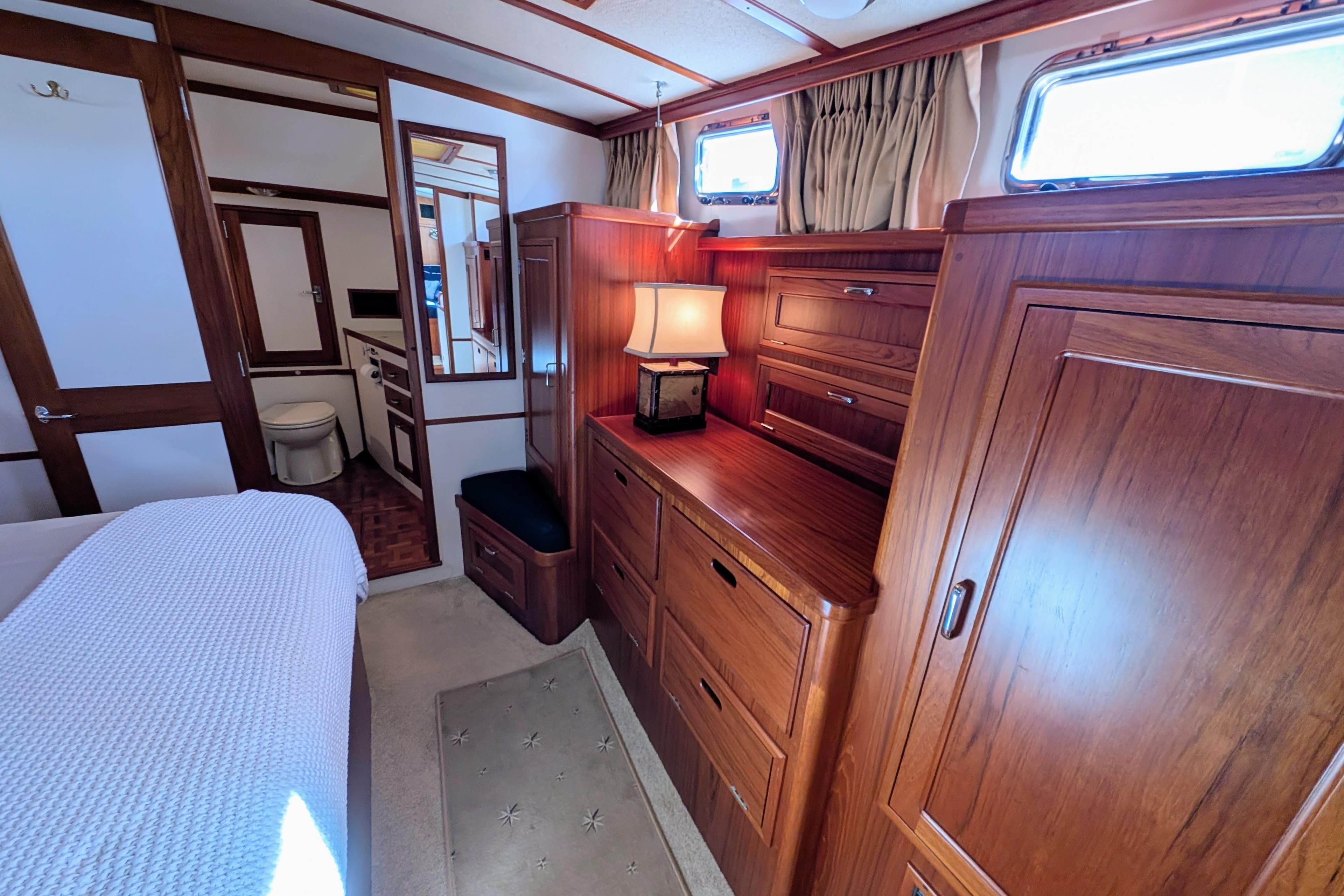 Luxurious 2001 Dettling 51 yacht interior with elegant wood cabinetry and cozy lighting.