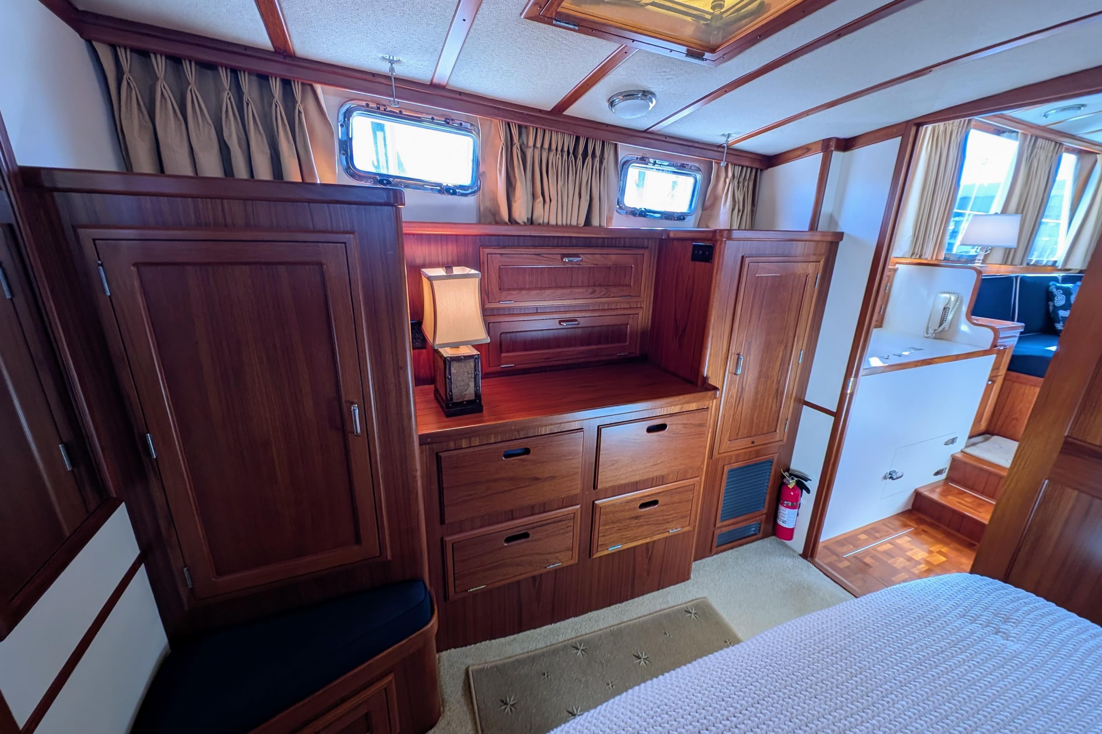 Luxurious wooden interior of a 2001 Dettling 51 yacht cabin with elegant furnishings.