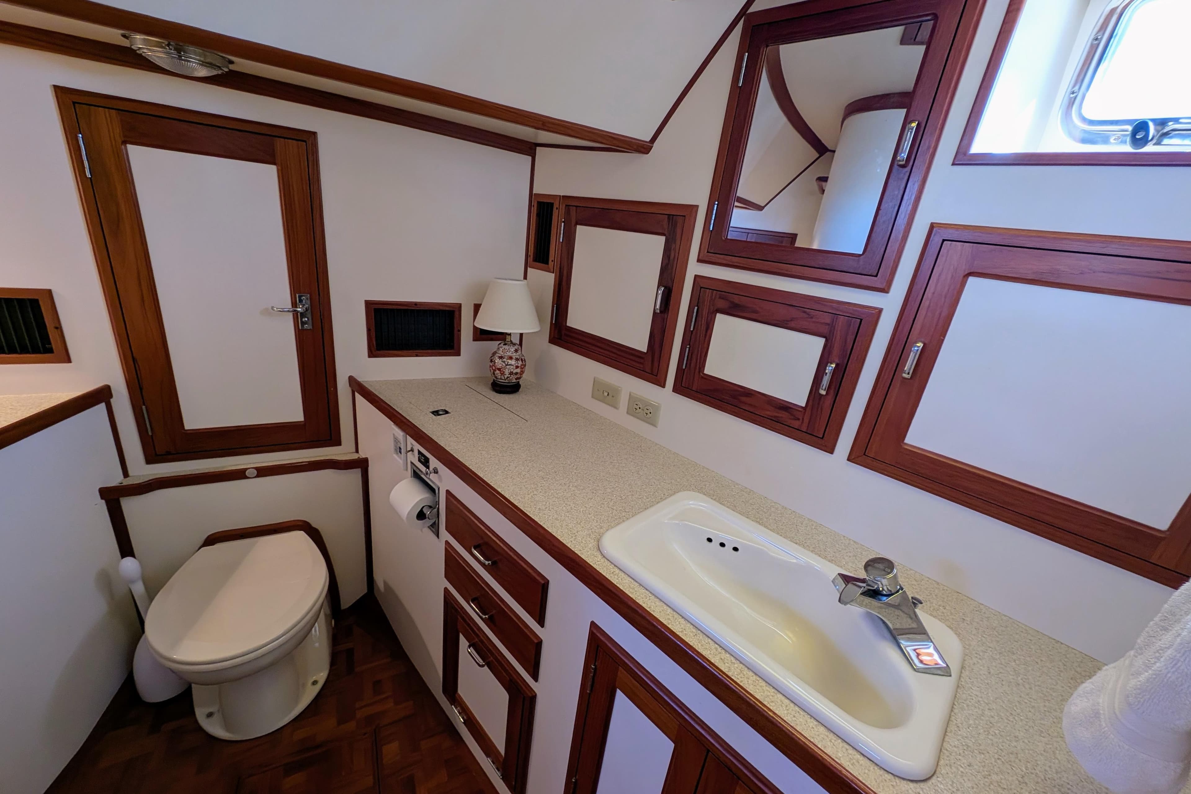 Luxurious Dettling 51 yacht bathroom, 2001 model, featuring wood accents and modern fixtures.