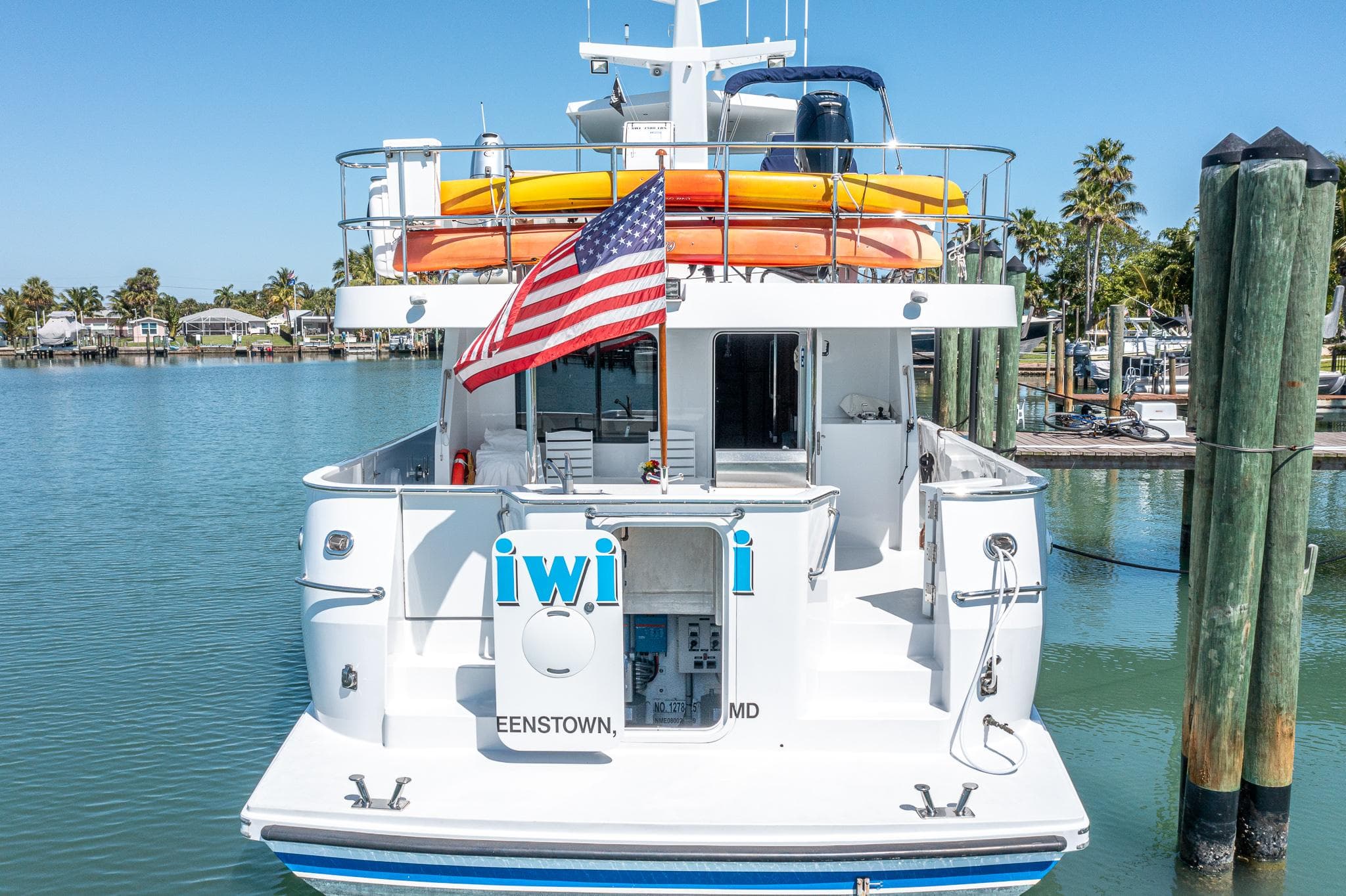 2017 Northern Marine Expedition yacht docked, displaying an American flag and vibrant kayaks.