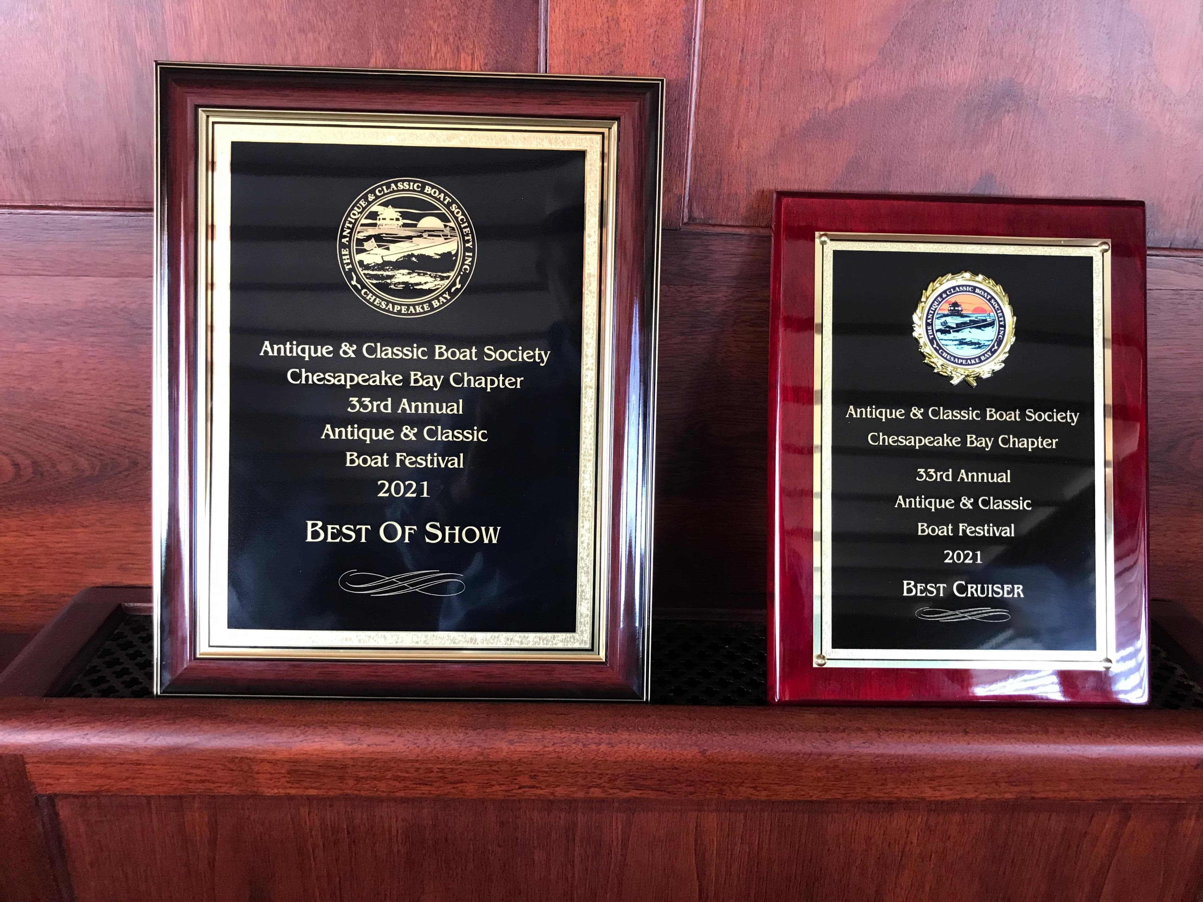 Two award plaques from the 2021 Antique & Classic Boat Festival, Best of Show and Best Cruiser.