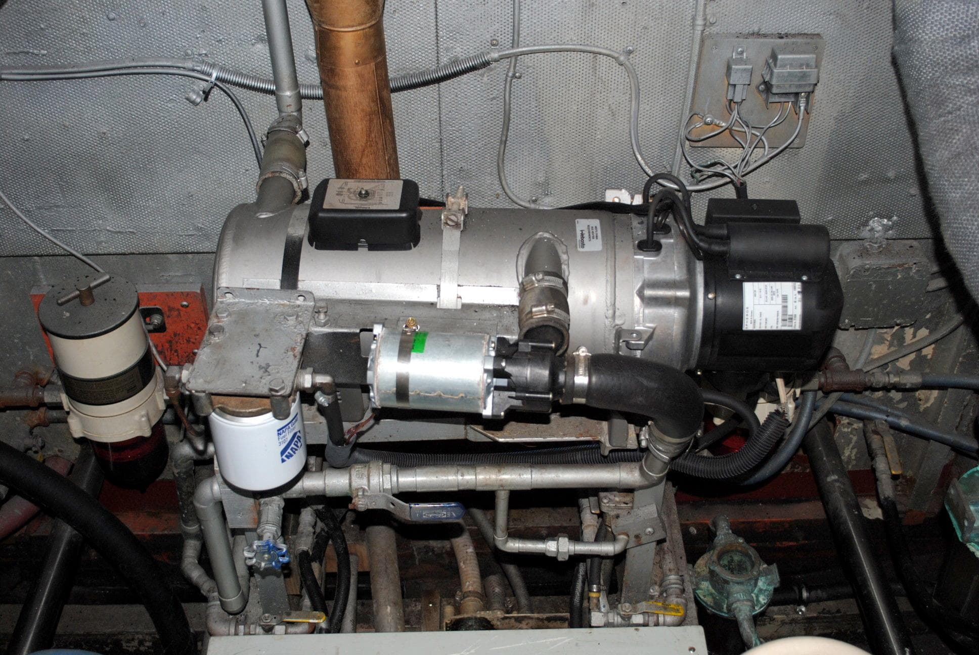 Engine room of 1947 Trumpy "60" Houseboat with visible machinery and wiring.