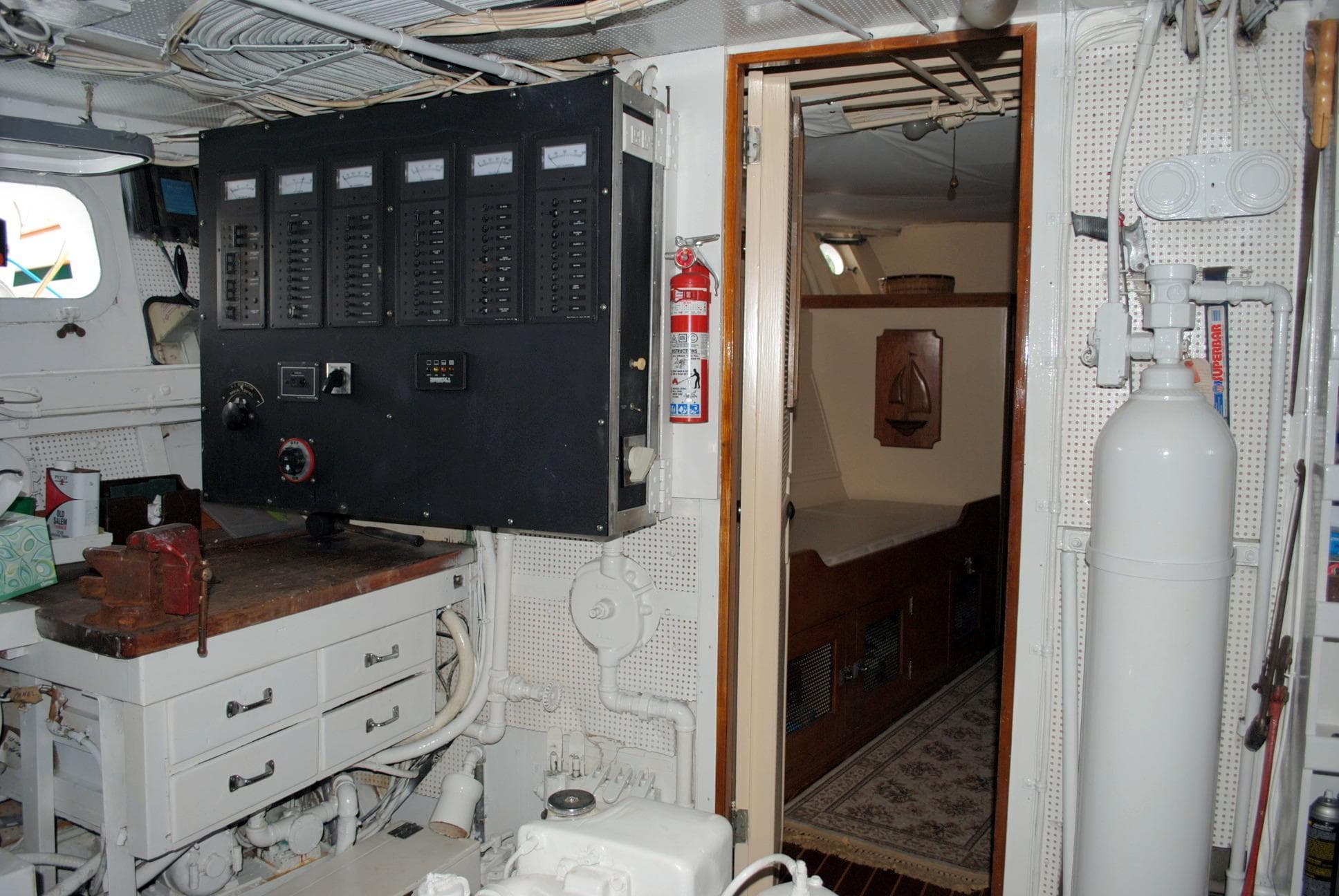 1947 Trumpy "60" Houseboat interior with control panel, storage, and cabin view.