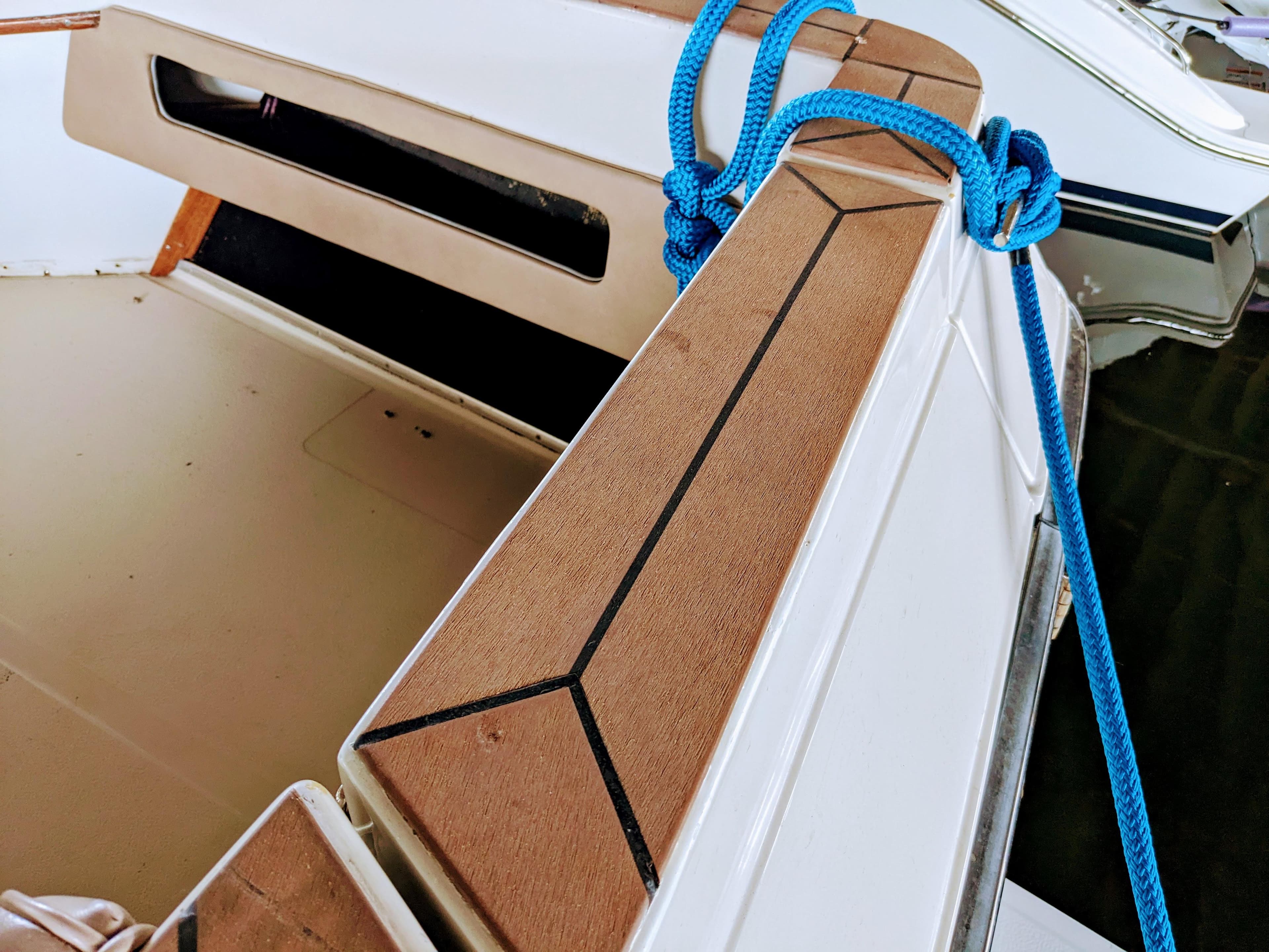 1988 Sea Ray 390 Express Cruiser with blue rope and teak deck detail.