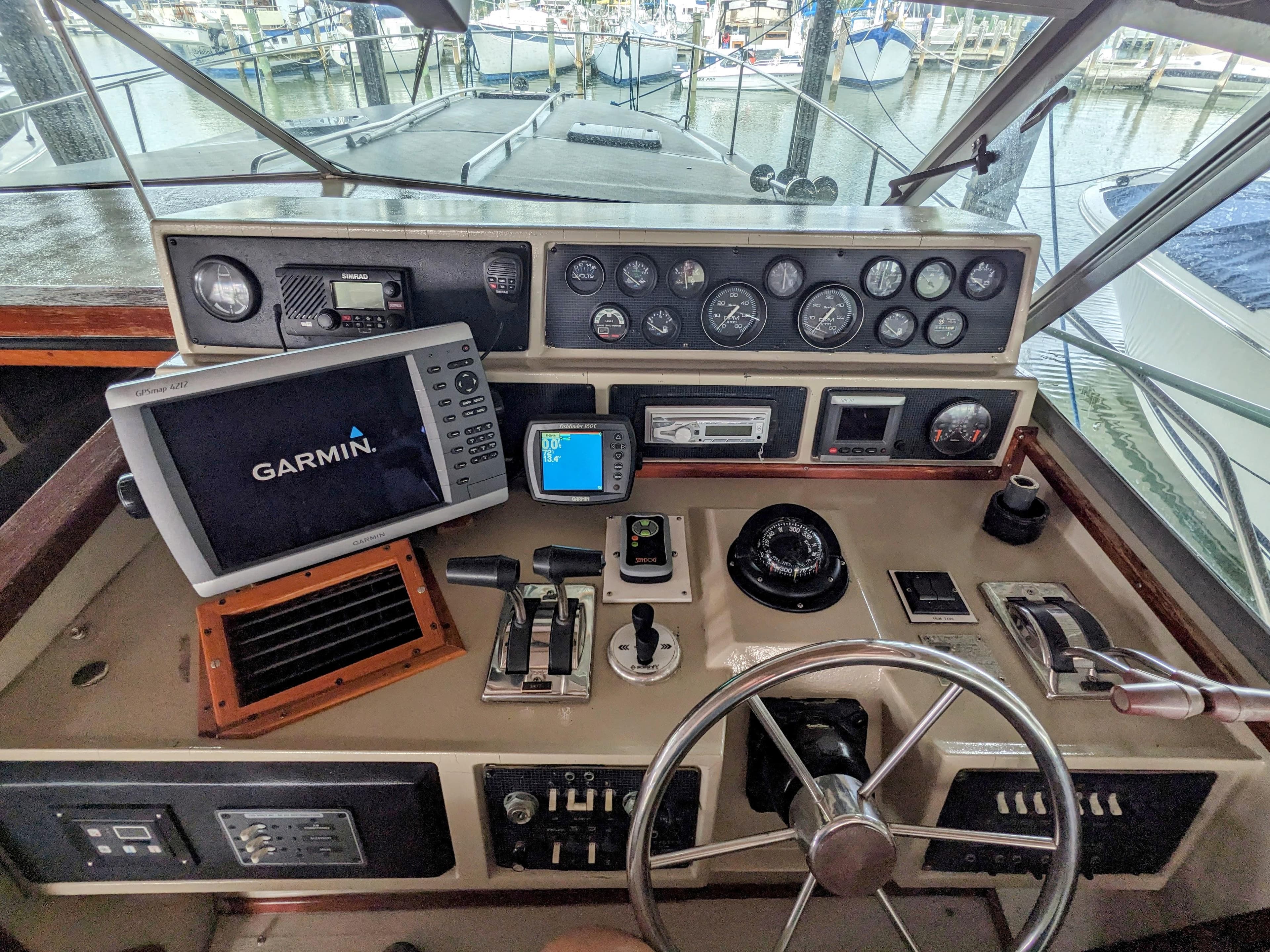 1988 Sea Ray 390 Express Cruiser helm with Garmin navigation system and control panel.