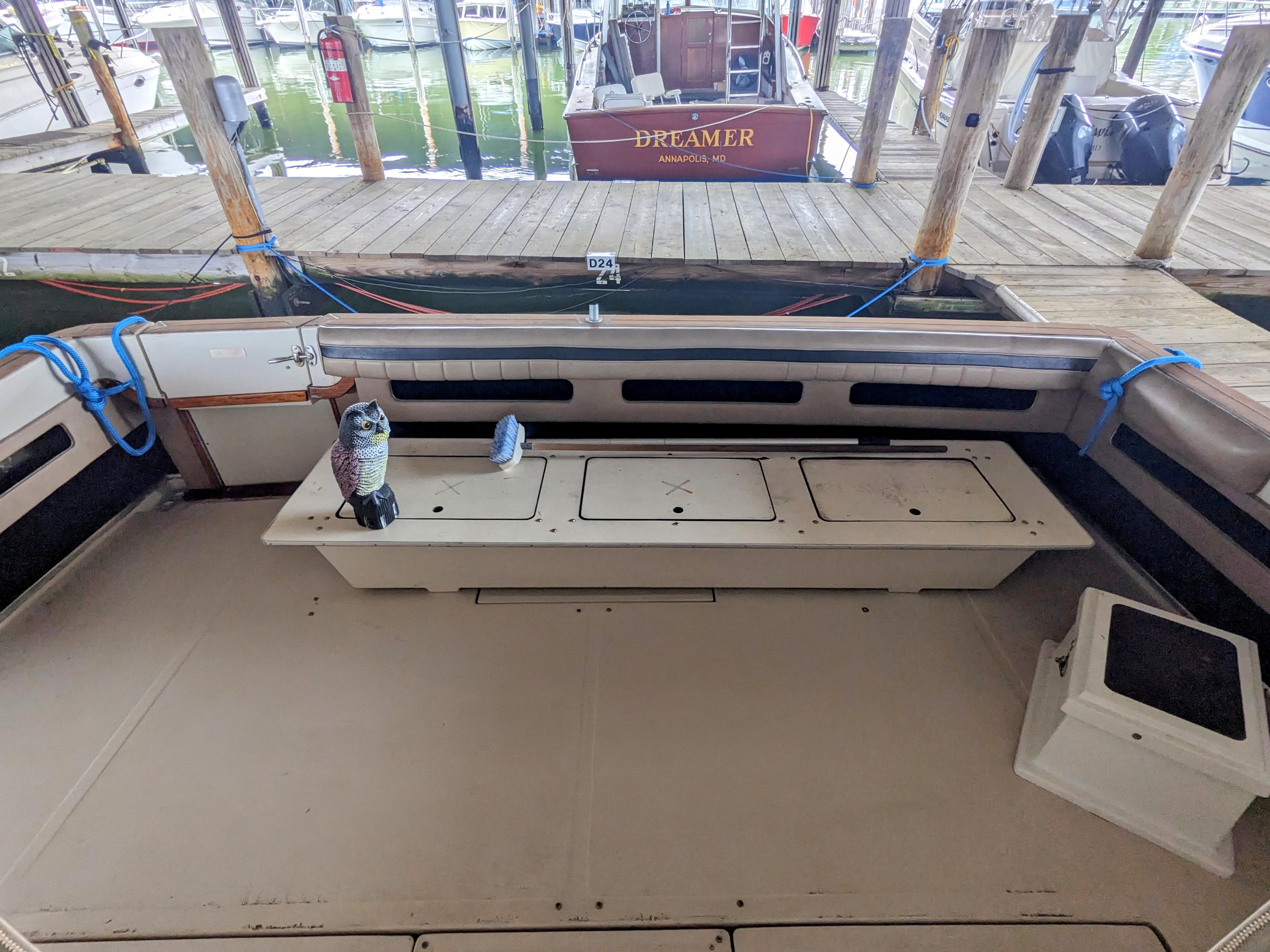 1988 Sea Ray 390 Express Cruiser interior with seating and dock view.