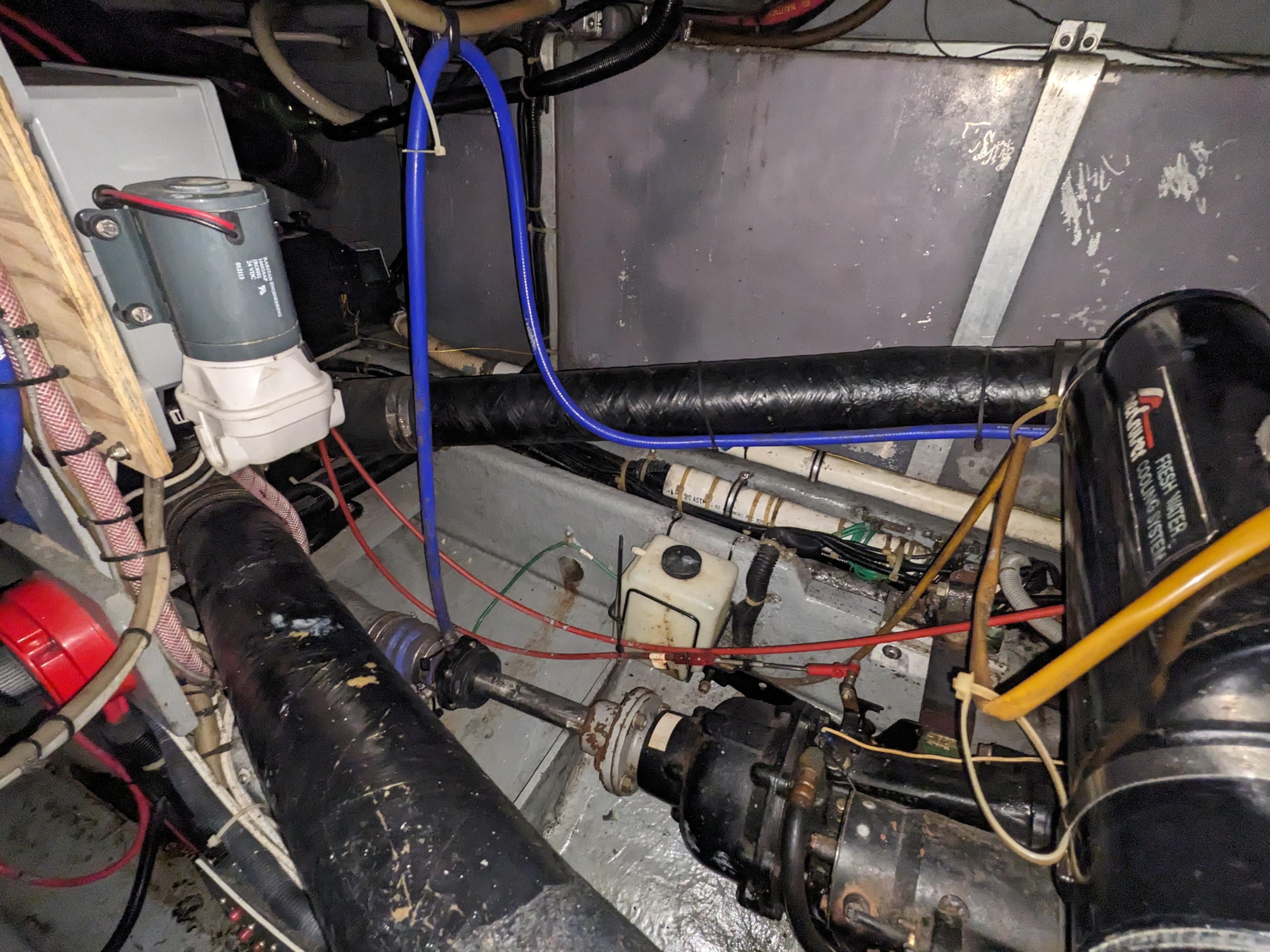 Engine room of a 1988 Sea Ray 390 Express Cruiser with visible wiring and components.