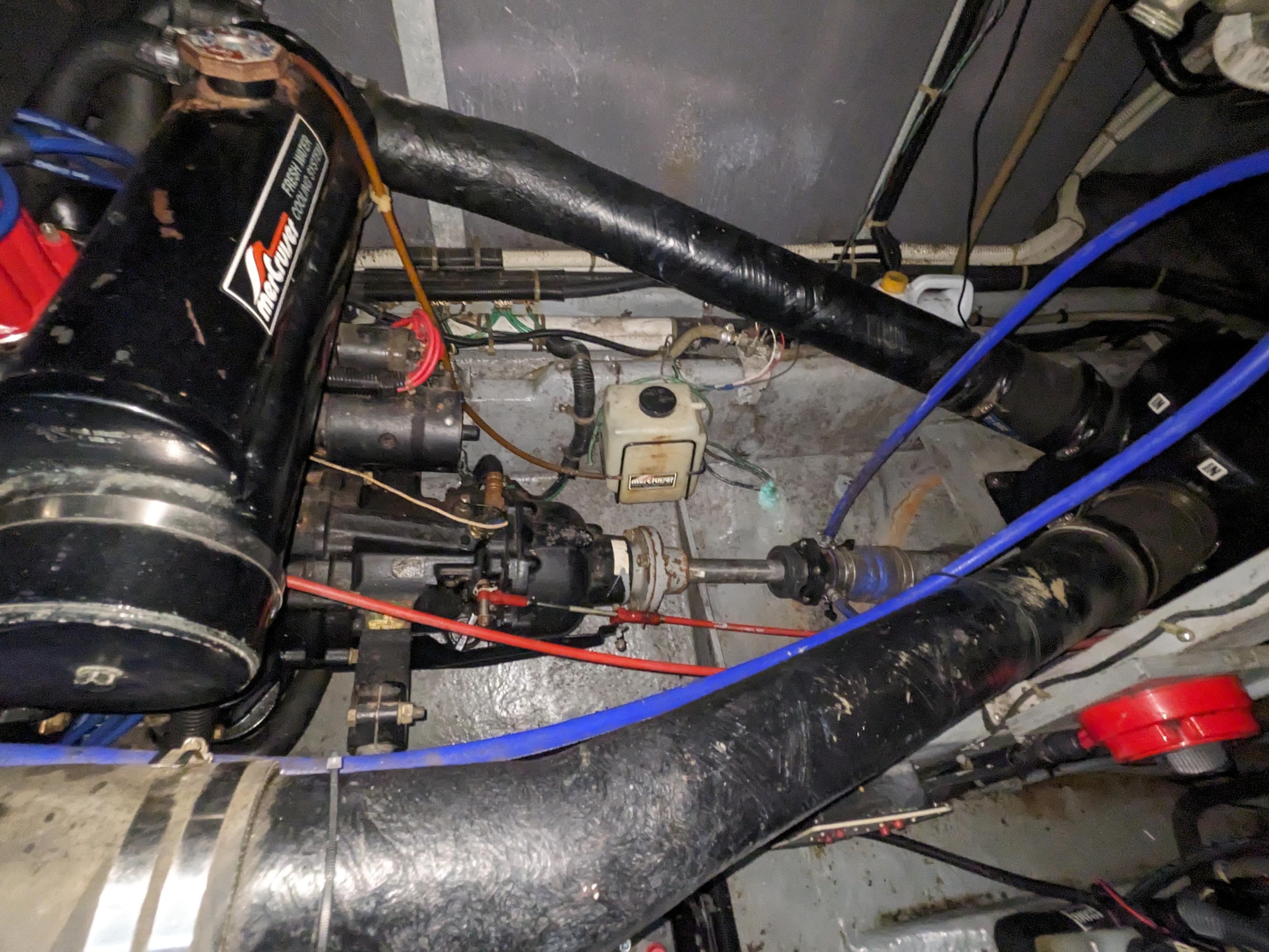 Engine compartment of a 1988 Sea Ray 390 Express Cruiser with visible components and wiring.