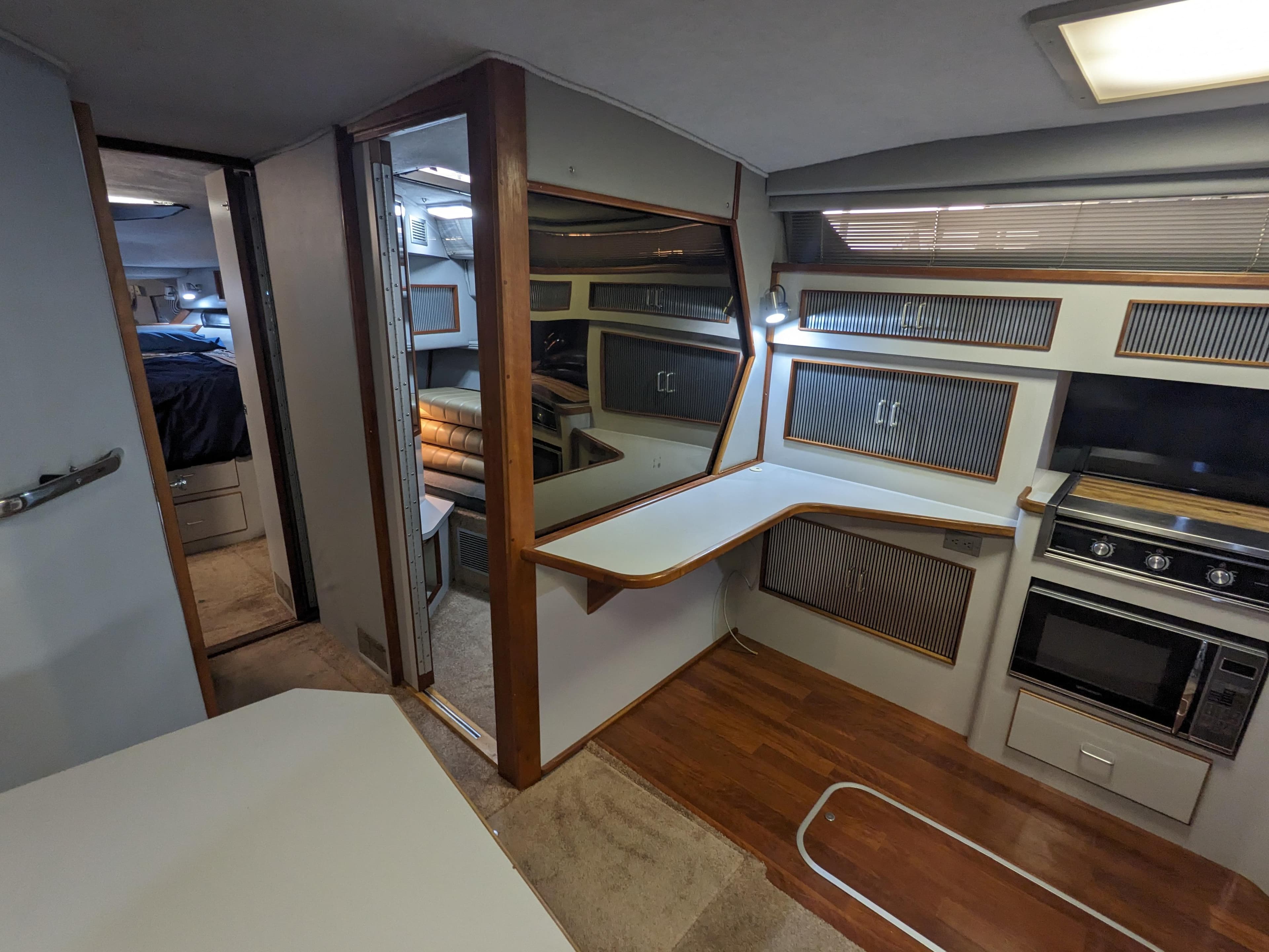Interior of 1988 Sea Ray 390 Express Cruiser with kitchen and seating area.